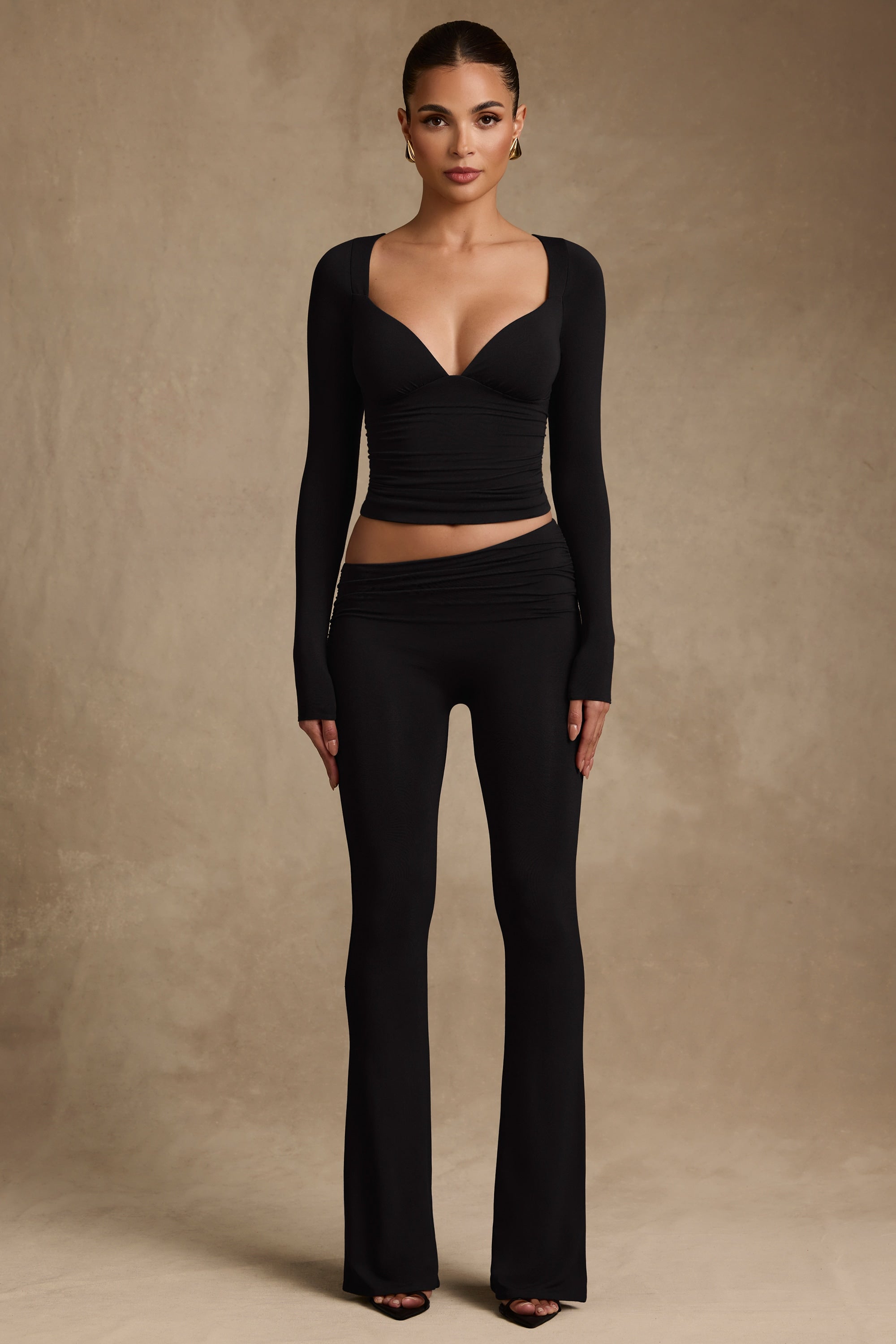 Kalei Modal Asymmetric-Waist Flared Trousers in Black Oh Polly