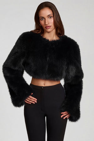 Oh Polly model Yasmin wearing the Almerinda Coat in Black Faux Fur fabric perfect for winter city strolls