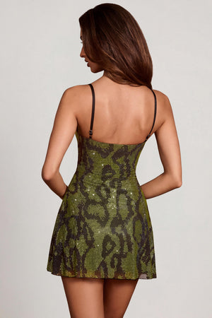 Oh Polly model Yasmin wearing the Dianora Mini Dress in Green Snake Square Hotfix fabric perfect for a night out