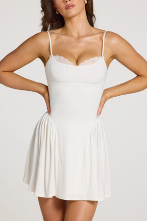 Oh Polly model Georgia wearing the Delphine Mini Dress in White Modal fabric perfect for birthday celebrations out