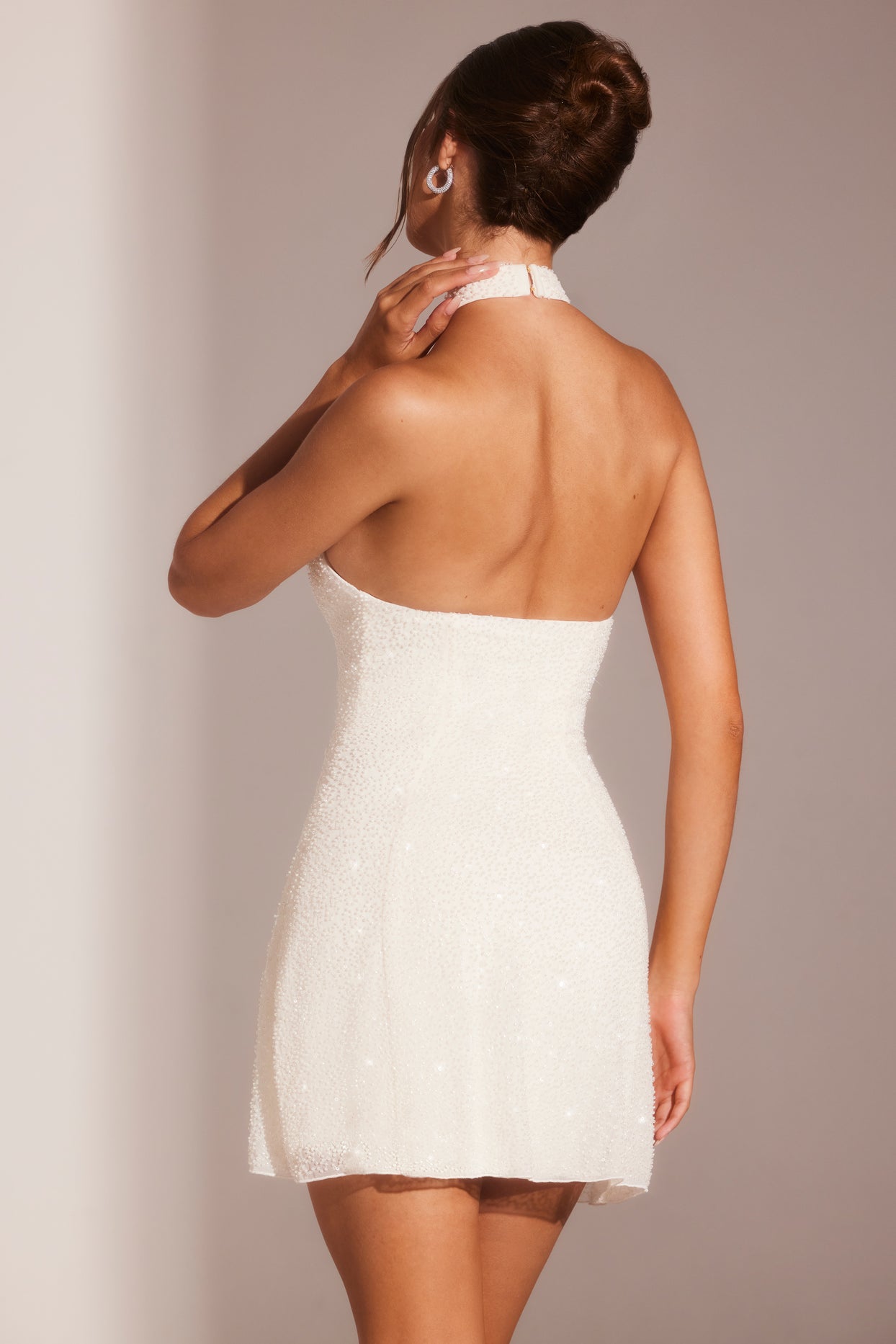 Mini-robe trapèze ornée à col asymétrique en blanc