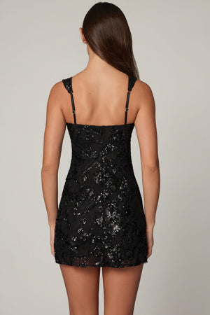 Oh Polly model Roberta wearing the Adia Mini Dress in Black Sequin, Chiffon fabric, perfect for cocktail parties
