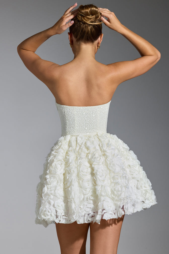 Biała, sznurowana sukienka mini ze zdobionymi kwiatowymi aplikacjami