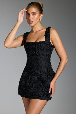 Gorsetowa mini sukienka z kwiatowymi aplikacjami w kolorze czarnym