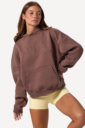 Bo+Tee model Lydia Butler wearing the CosyCoffeeRunWithLydsButler Hoodie in Cocoa Brushback sweat fabric perfect for morning coffee runs