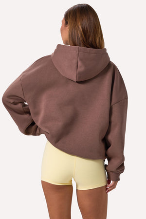 Bo+Tee model Lydia Butler wearing the CosyCoffeeRunWithLydsButler Hoodie in Cocoa Brushback sweat fabric perfect for cozy study sessions