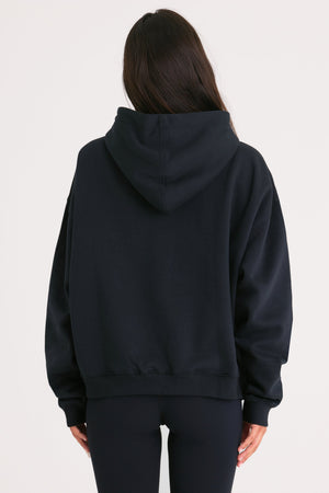 Bo+Tee model Cristal wearing the Off-Duty Hoodie in Black Cotton fabric perfect for weekend errands
