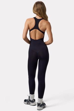 Bo+Tee model Virginia Sanhouse wearing the Silhouette Jumpsuit (reg) in Black Define Luxe (Seamless) fabric perfect for running errands