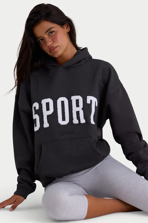Bo+Tee model Kiele wearing the Varsity Hoodie in Black Cotton fabric perfect for weekend brunch