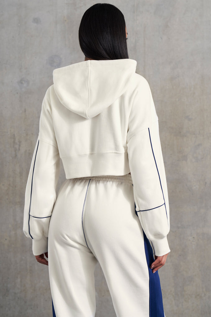Veste courte à capuche zippée doublée gaufrée en blanc