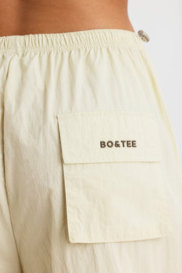 BT1171 Spodnie dresowe z odpinanymi nogawkami w kolorze kości