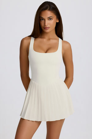 Soft Active Open-Back Pleated Tennis Dress in Coconut | Bo+Tee Oh Polly UK Soft Active Open-Back Pleated Tennis Dress in Coconut | Bo+Tee Oh Polly UK
