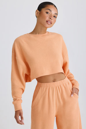 Textured Cotton Jersey Open-Back Cropped Sweatshirt in Peach