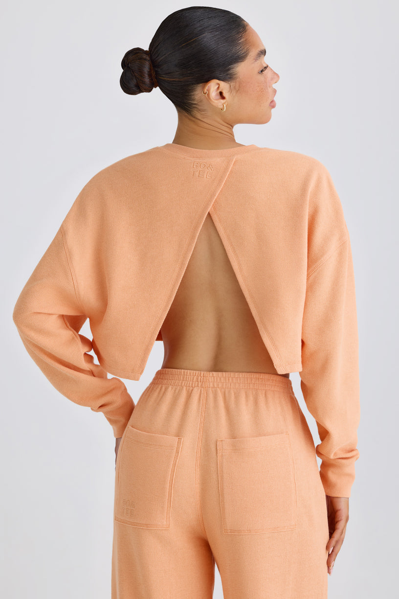 Textured Cotton Jersey Open-Back Cropped Sweatshirt in Peach - 1