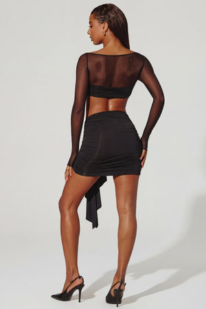 Oh Polly's Kiele wearing the Banks Mini Skirt in Black Slinky fabric perfect for a night out