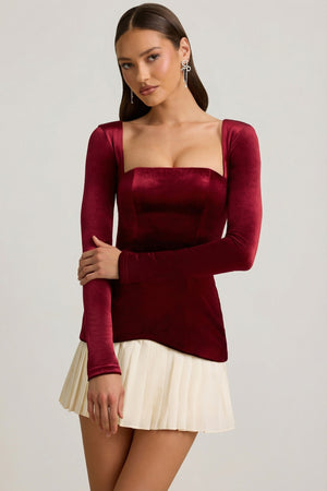 Oh Polly's Anna wearing the Darline Mini Dress in Wine Red Velvet fabric perfect for festive gatherings