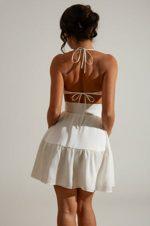 Oh Polly's Cenit wearing the Fleur Mini Dress in White Satin fabric perfect for stylish cocktail hours