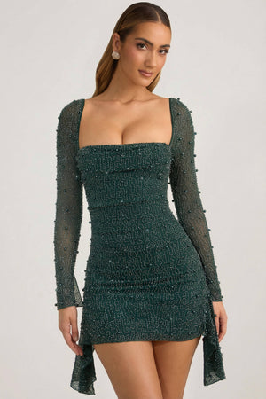 Oh Polly's Priscilla wearing the Tivoli Mini Dress in Green Embellished fabric perfect for summer garden parties