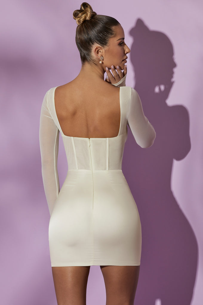 Sukienka mini z długim rękawem i siatkowym gorsetem w kolorze białym