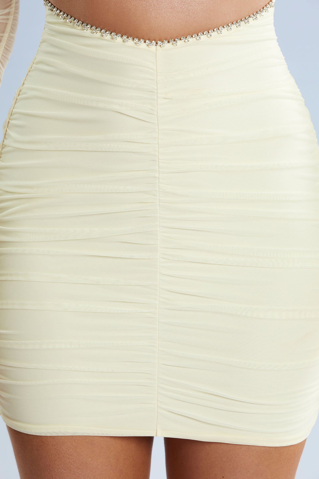 Close up of Long Sleeve Cut Out Mini Dress in Ivory