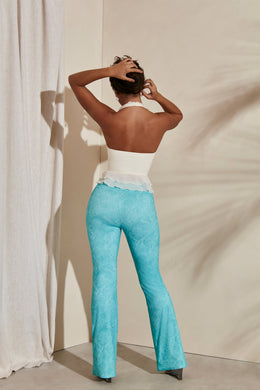 Back view of pull on design - Flare trousers in teal print.