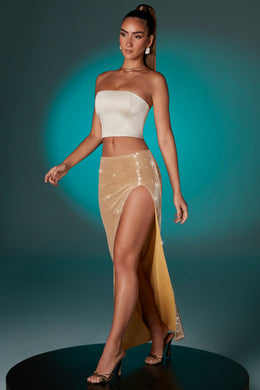 Płaska cekinowa spódnica maxi z rozcięciem na udzie w kolorze złotym