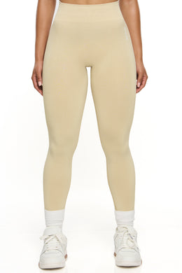Front view of high waisted sports leggings in beige