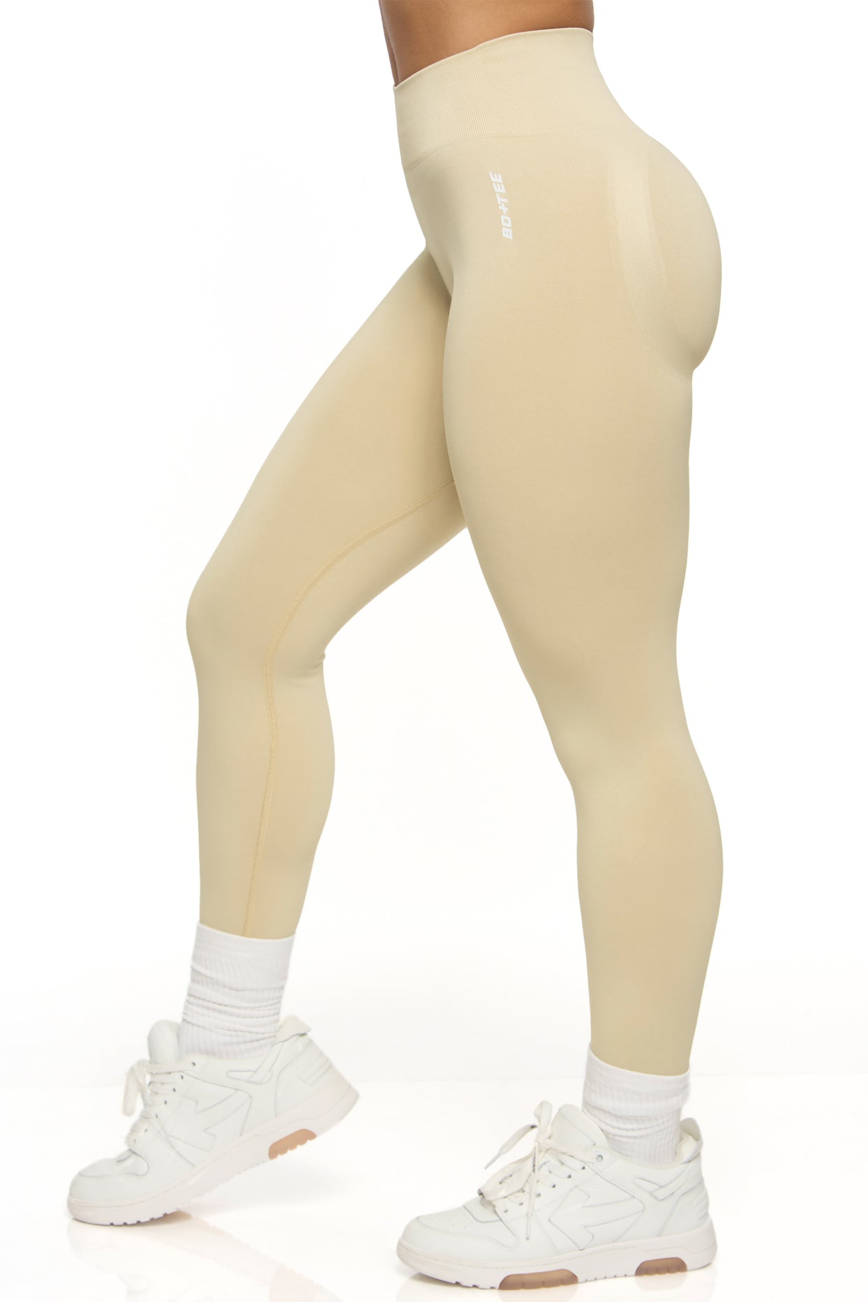 Side view of high waisted sports leggings in beige