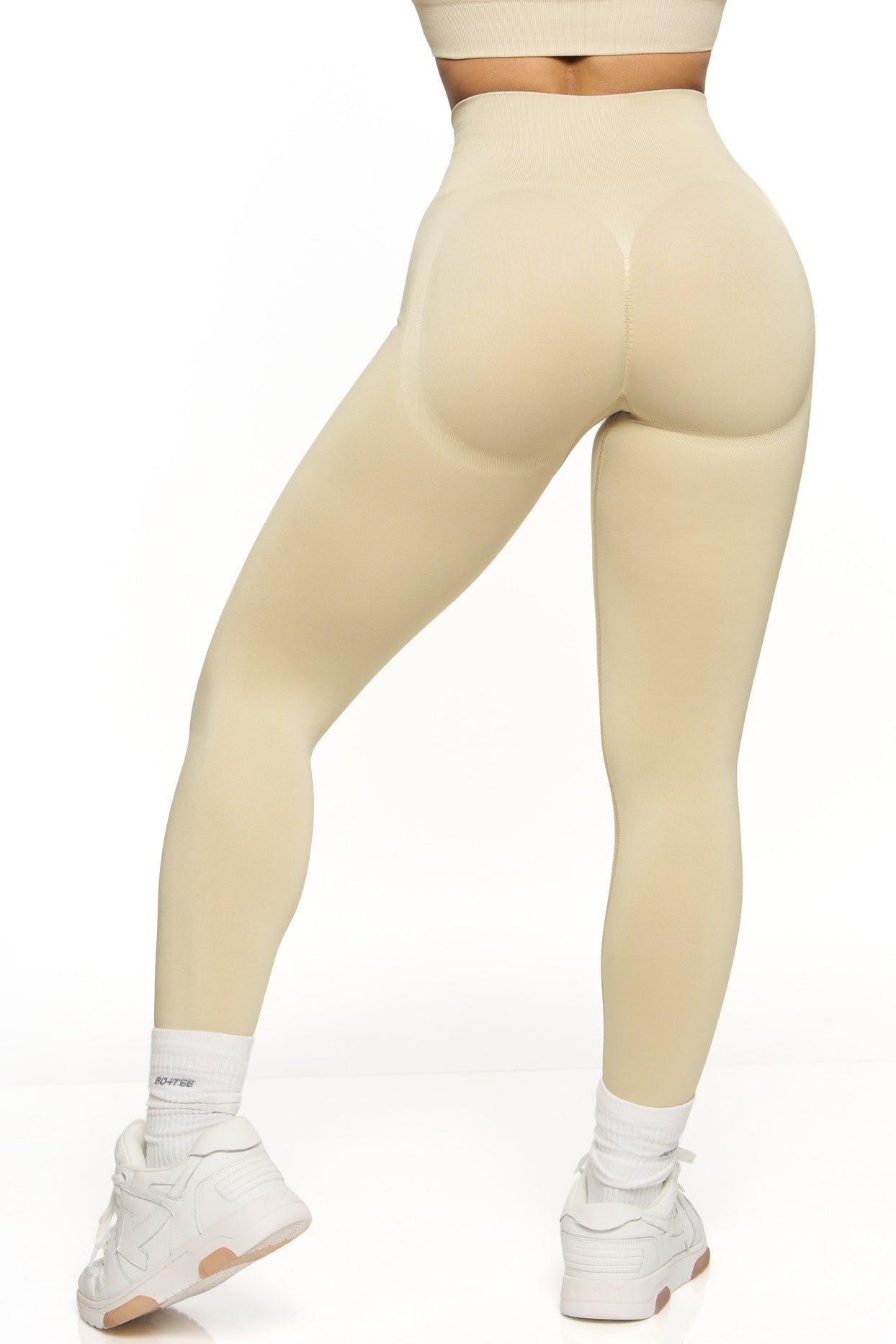 Back view of high waisted sports leggings in beige