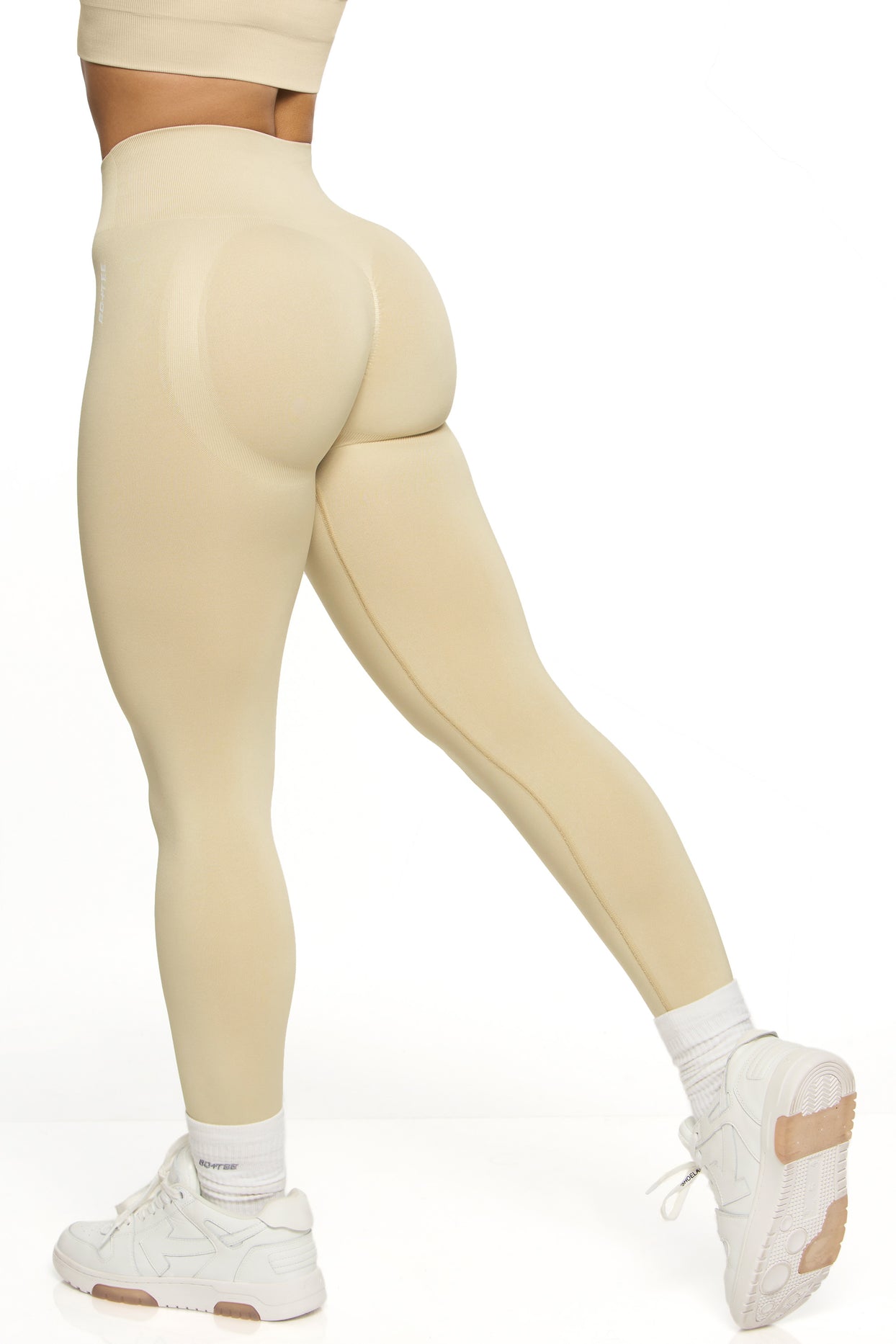Back view of high waisted sports leggings in beige