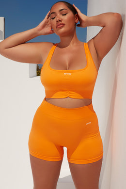 Biustonosz sportowy z promienistymi marszczeniami w kolorze pomarańczowym